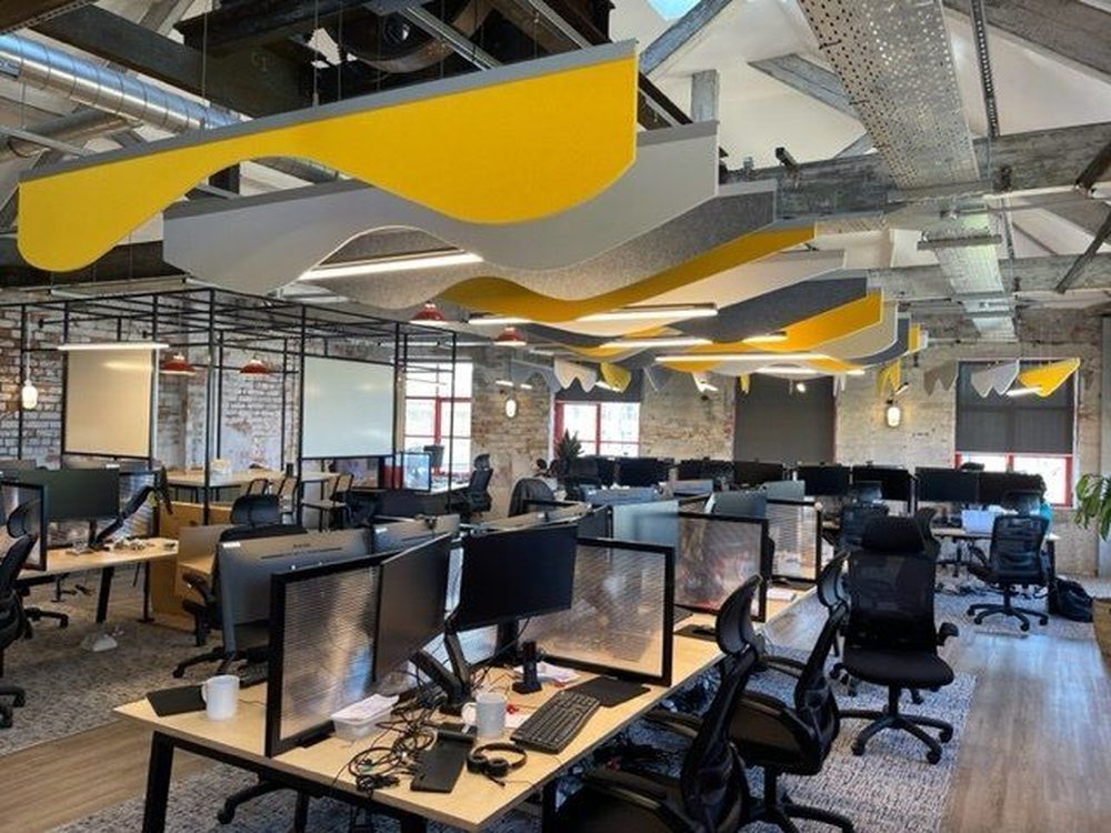 Open plan office with acoustic ceiling rafts