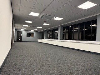Office floor with glazed partitions and grid ceiling