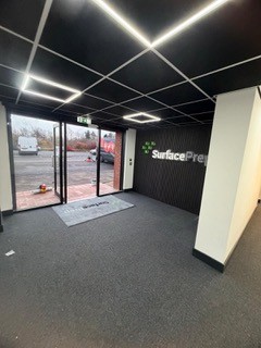 Reception entrance with linear lighting and branded feature wall